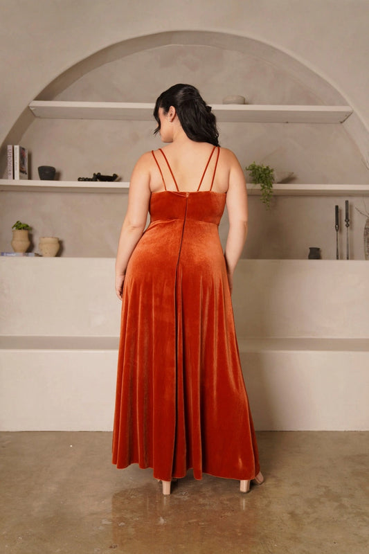 Back view of plus size burnt orange evening dress featuring double spaghetti straps, straight back, center zipper and elegant velvet-look A-line skirt.