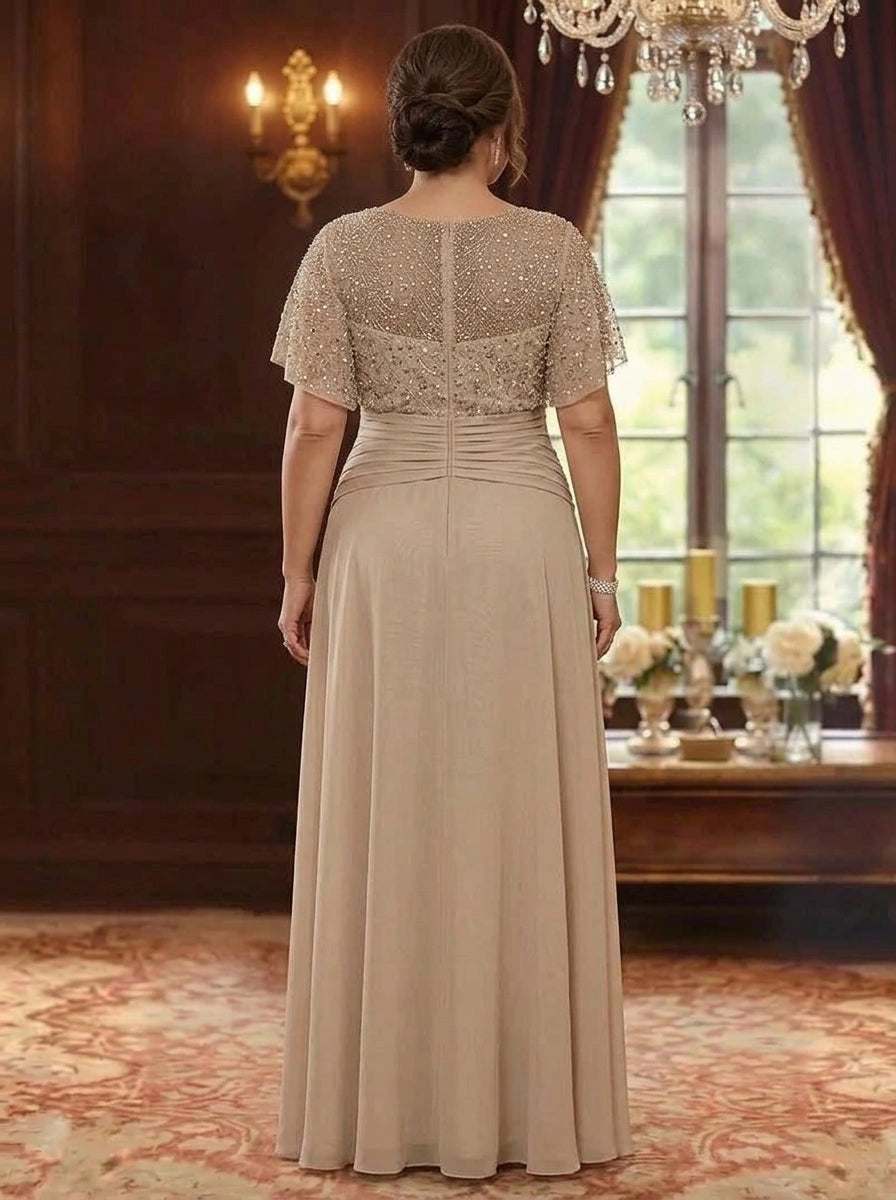 Back view of plus size champagne mother of the bride dress featuring sheer beaded back panel, short sleeves and center zipper closure.