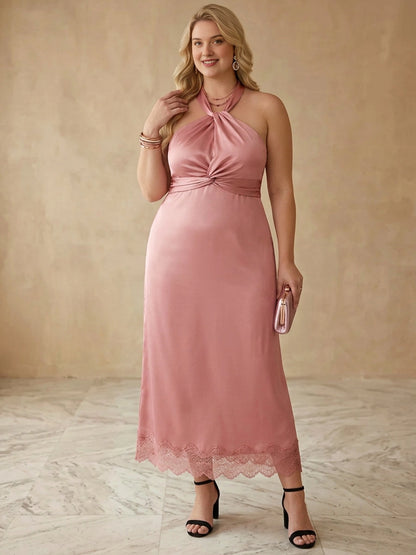 Plus size dusty rose satin halter wedding guest dress with twist knot bust, twisted waist and lace trim midi slip skirt, front view
