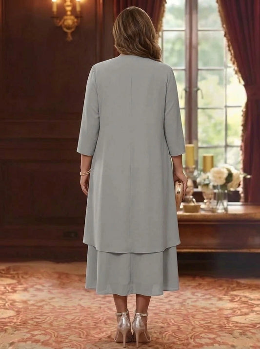 Back view of plus size gray mother of the bride dress featuring elegant jacket overlay, simple back design and center zipper closure.