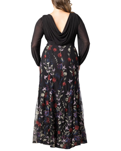 Back view of plus size black floral jacquard wedding guest dress featuring draped back, long sleeves and embroidered flowing skirt.