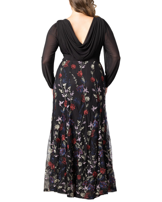 Back view of plus size black floral jacquard wedding guest dress featuring draped back, long sleeves and embroidered flowing skirt.