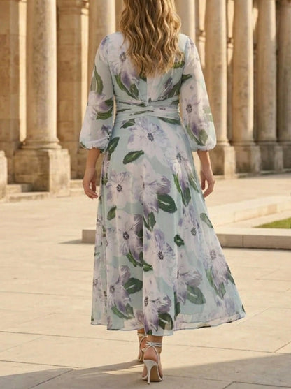 Back view of plus size floral wedding guest dress featuring puff sleeves, floral chiffon design and center zipper closure.