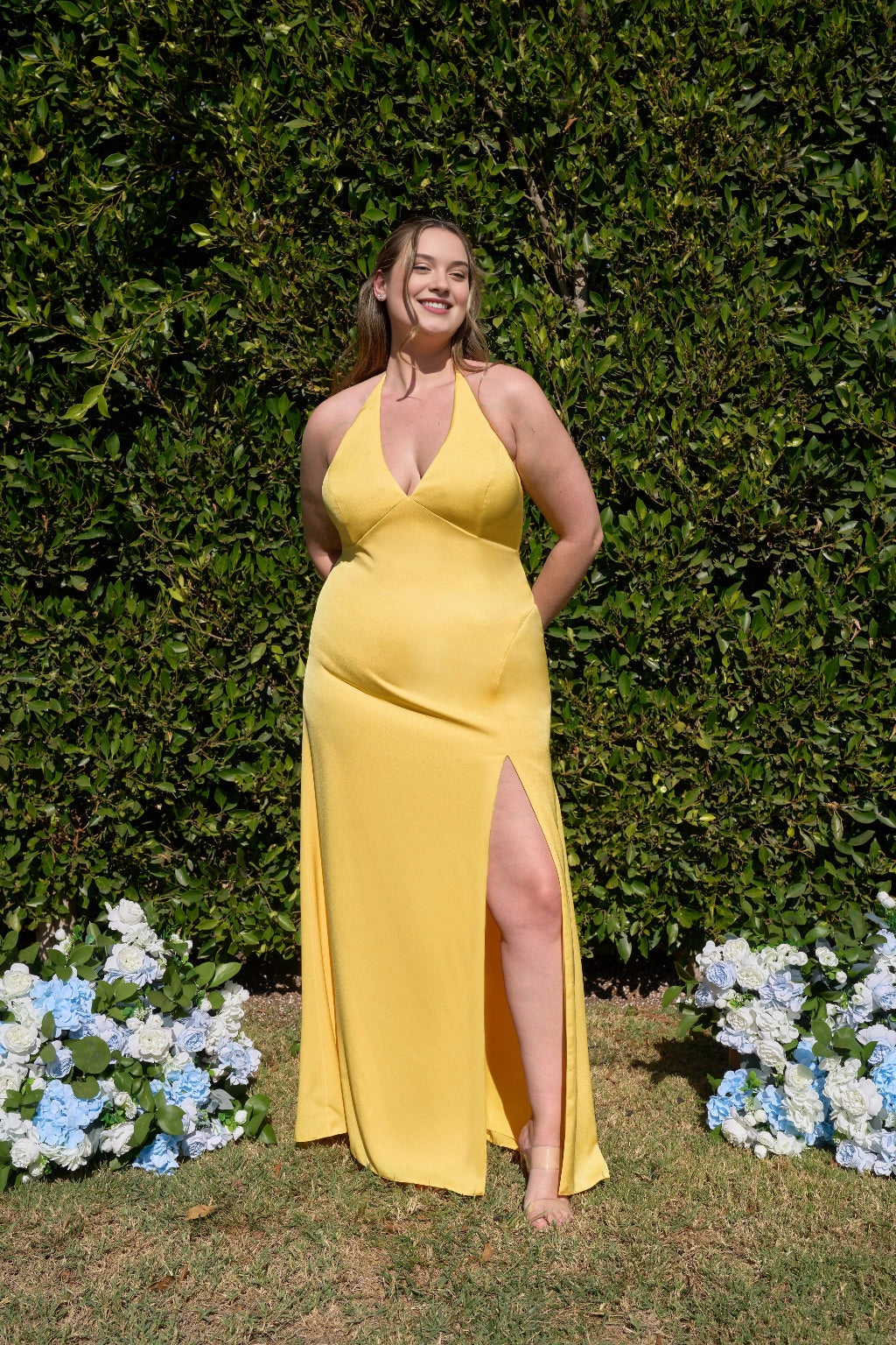 Plus size sunshine yellow bridesmaid dress with plunging V-neckline, halter straps, fitted waist, high slit and flowing floor-length skirt by roselledress.