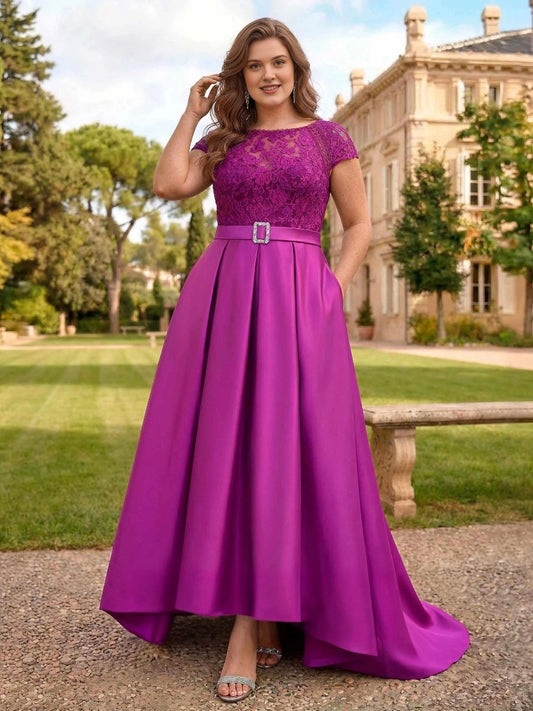 Plus size magenta lace bodice mother of the bride dress with satin waistband, rhinestone buckle, cap sleeves, pockets and high-low A-line skirt, front view

