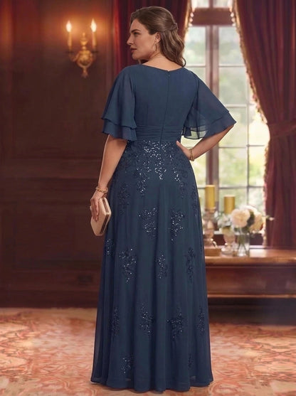 Back view of plus size navy blue mother of the bride dress featuring flutter sleeves, embroidered skirt and center zipper closure.