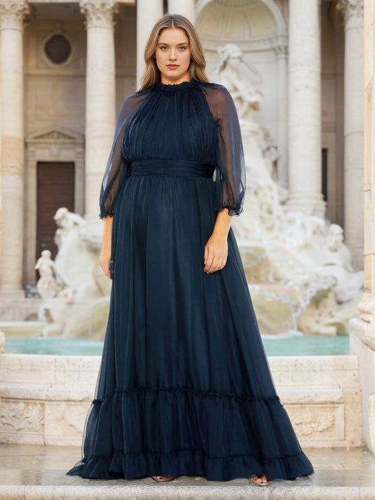 Plus size navy chiffon mother of the bride dress with high ruffled neck, sheer balloon sleeves, ruched waist and tiered flowing floor length skirt, front view

