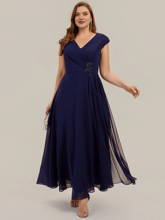 Plus size navy chiffon mother of the bride dress with V-neck, beaded neckline trim, cap sleeves, beaded applique at waist and flowing A-line long skirt, front view
