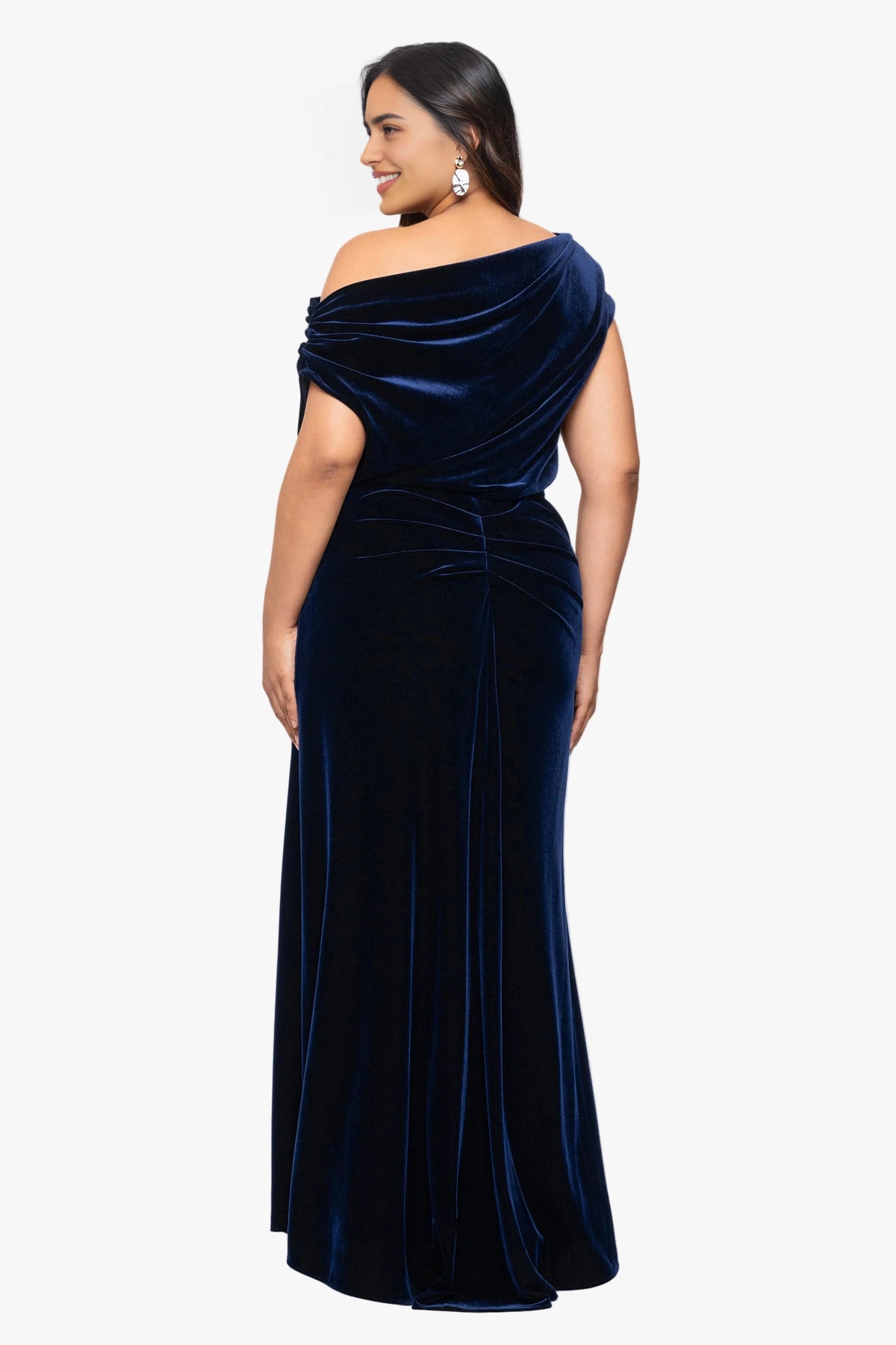 Back view of navy blue plus size velvet wedding guest dress featuring asymmetric draped neckline, gathered waist and flowing maxi skirt by roselledress