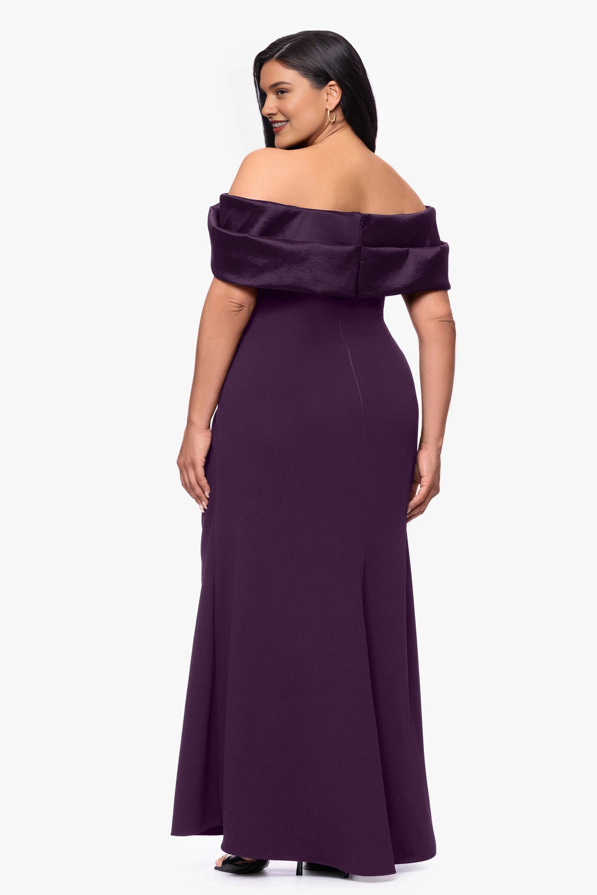Back view of plum plus size wedding guest dress with folded off-shoulder neckline, center-back zipper and elegant floor-length skirt.