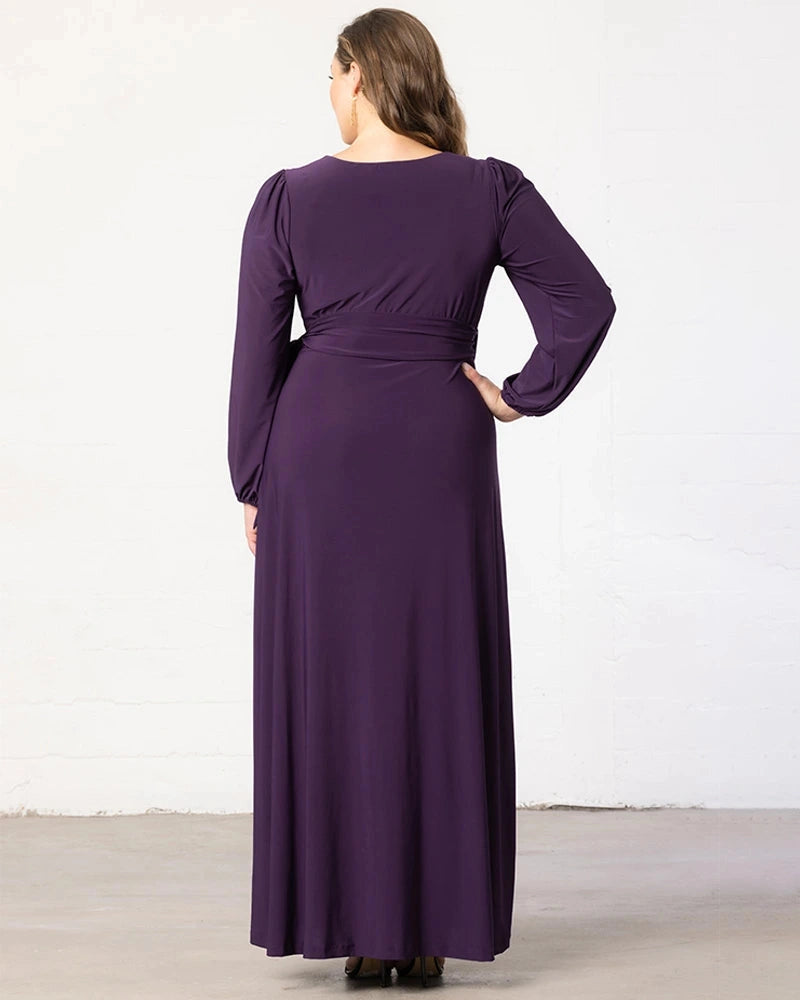 Back view of plum purple plus size wedding guest dress featuring a modest round back, long sleeves, fitted waist and flowing maxi skirt by roselledress