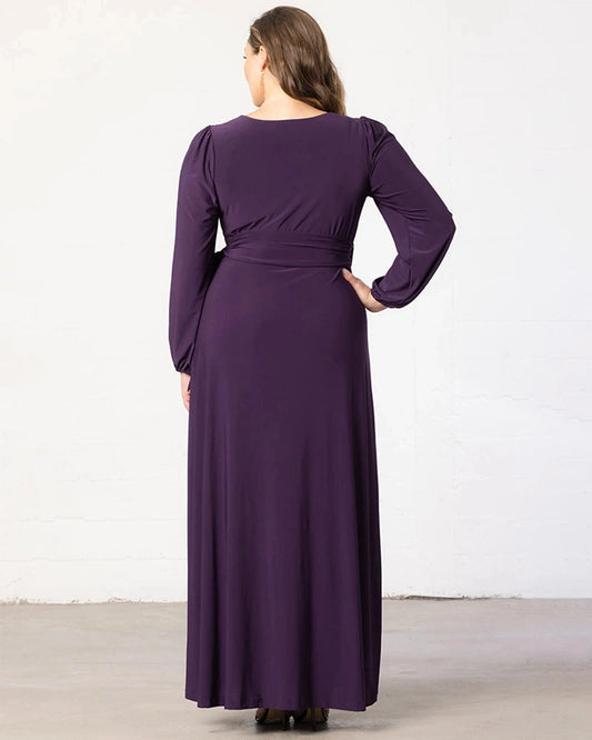 Back view of plum purple plus size wedding guest dress featuring a modest round back, long sleeves, fitted waist and flowing maxi skirt by roselledress