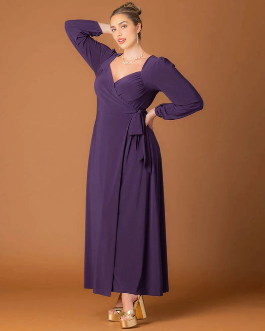 Plum purple plus size wedding guest dress with surplice V-neckline, long puff sleeves, side waist tie and flowing A-line maxi skirt by roselledress