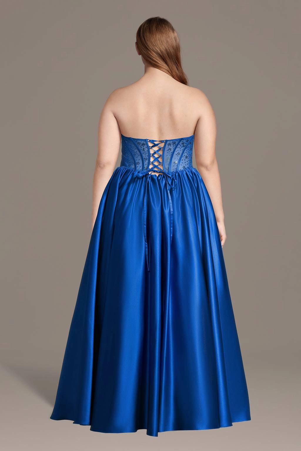 Back view of plus size royal blue evening dress featuring lace-up corset back, adjustable ribbon closure and floor-length satin skirt.