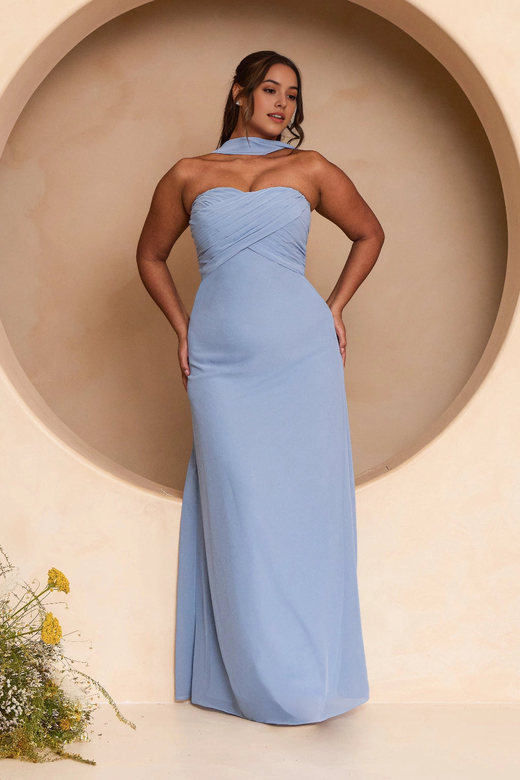 Plus size dusty blue bridesmaid dress with sweetheart neckline, crisscross ruched bodice, draped neck scarf and elegant floor-length sheath silhouette.