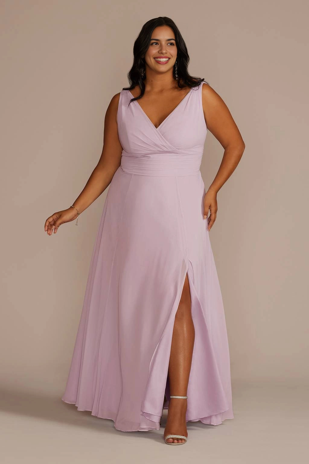 Plus size dusty lilac wedding guest dress with V-neckline, sleeveless design, ruched waist, front slit and flowing A-line skirt by roselledress.