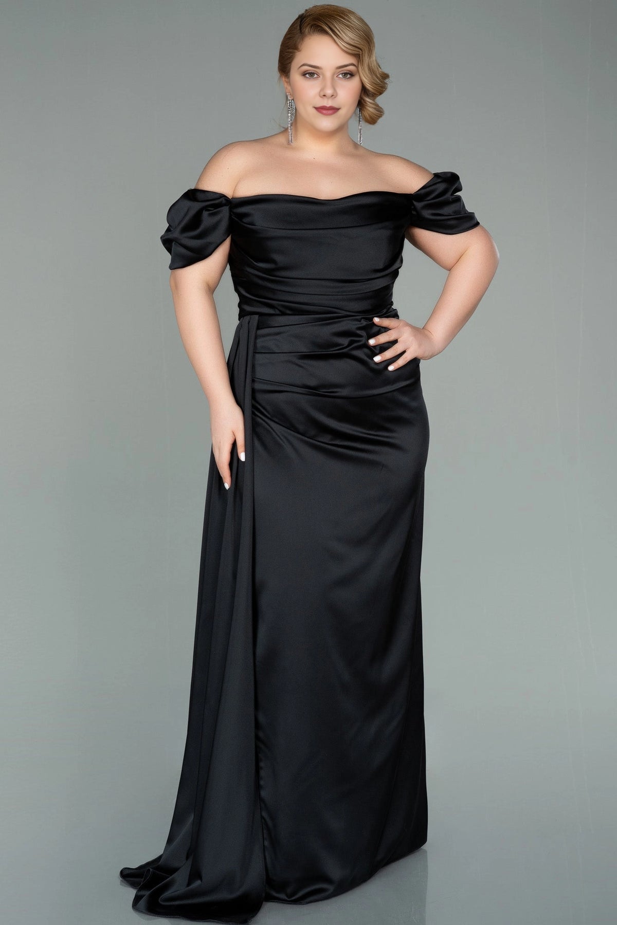 Front view of a roselledress plus size black satin off shoulder long evening dress with side drape