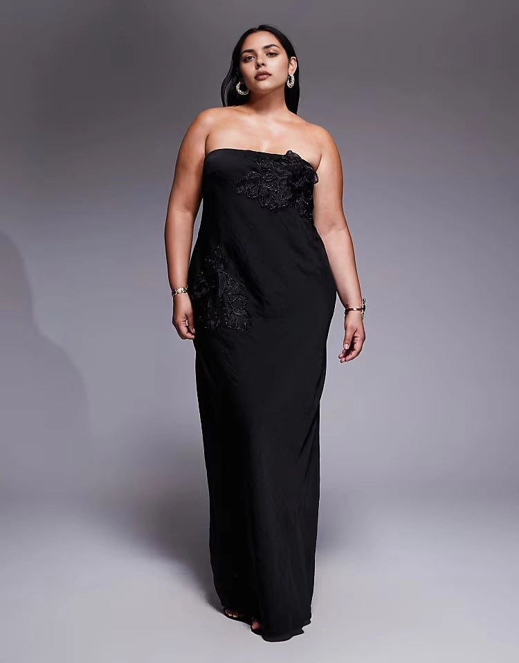 Roselledress plus size black strapless column maxi wedding guest dress with lace appliqué front view on curvy model