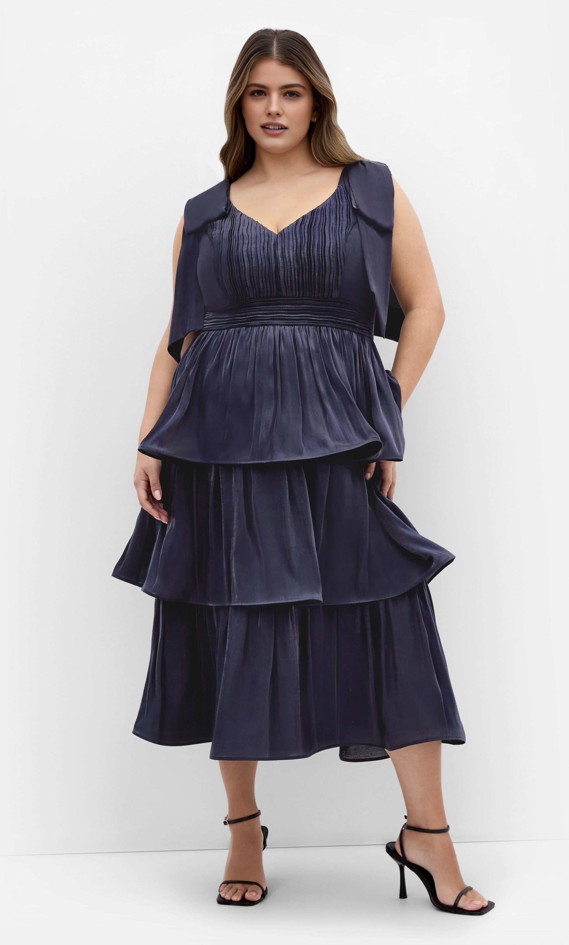 Roselle Dress plus size navy satin tiered midi gown, v‑neck sleeveless bow‑strap wedding guest dress front view